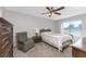 Cozy bedroom with double bed, dresser, and ceiling fan at 7379 Rosemont Dr, Englewood, FL 34224