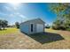 Detached garage with white door and gray exterior at 7379 Rosemont Dr, Englewood, FL 34224