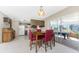 Dining area with kitchen and sunroom views, seating for four at 7379 Rosemont Dr, Englewood, FL 34224