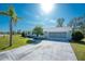 House exterior showcasing front entrance and palm trees at 7379 Rosemont Dr, Englewood, FL 34224