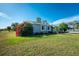 Single story home with gray exterior and red flowers at 7379 Rosemont Dr, Englewood, FL 34224