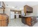 Galley style kitchen with white appliances and wood cabinets at 7379 Rosemont Dr, Englewood, FL 34224