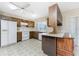 Kitchen features white appliances and wood cabinets at 7379 Rosemont Dr, Englewood, FL 34224