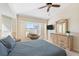 Relaxing bedroom featuring a large window and dresser at 738 Boundary Blvd, Rotonda West, FL 33947