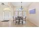 Formal dining room with glass-top table and chairs, near the front entrance at 738 Boundary Blvd, Rotonda West, FL 33947