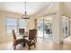 Casual dining area with glass table and wicker chairs, near sliding doors to the pool at 738 Boundary Blvd, Rotonda West, FL 33947