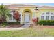 Charming yellow house with landscaping and a walkway to the front door at 738 Boundary Blvd, Rotonda West, FL 33947