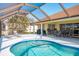 Relaxing pool and patio area with ample seating and a screened enclosure at 738 Boundary Blvd, Rotonda West, FL 33947