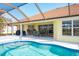 Inviting pool area with covered patio, outdoor seating, and grilling station at 738 Boundary Blvd, Rotonda West, FL 33947