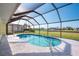 Refreshing screened-in pool with a view of the canal and neighborhood at 738 Boundary Blvd, Rotonda West, FL 33947