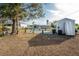 Backyard view of home, shed, and patio area at 850 E 2Nd St, Englewood, FL 34223