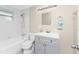 Bathroom with tub, shower and gray vanity at 850 E 2Nd St, Englewood, FL 34223