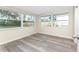 Bright bedroom with wood-look floors and large windows at 850 E 2Nd St, Englewood, FL 34223