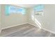 Bedroom with wood-look floors and two windows at 850 E 2Nd St, Englewood, FL 34223