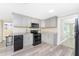 Renovated kitchen with gray cabinets and stainless steel appliances at 850 E 2Nd St, Englewood, FL 34223