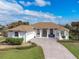 Single-story home with a light-colored facade, brown roof, and a long driveway at 110 Barracuda Dr, Placida, FL 33946