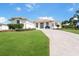 Landscaped lawn with a long driveway leading to the house at 110 Barracuda Dr, Placida, FL 33946