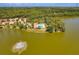 Aerial view of community pool, clubhouse, and lake at 11479 Blackfin St, Venice, FL 34292