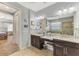 Bathroom with double vanity and view into the main bedroom at 11479 Blackfin St, Venice, FL 34292