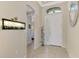 Neutral-toned entryway with tile floors and an arched doorway at 11479 Blackfin St, Venice, FL 34292