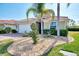 Landscaped front yard with a single-story house and palm trees at 11479 Blackfin St, Venice, FL 34292