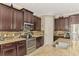 Well-equipped kitchen with dark cabinets and granite counters at 11479 Blackfin St, Venice, FL 34292