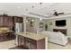 Kitchen with island overlooks living room with TV at 11479 Blackfin St, Venice, FL 34292