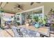 Outdoor patio with dining table, chairs, and lush greenery at 11479 Blackfin St, Venice, FL 34292