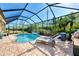 Inviting kidney-shaped pool with screened patio and lounge chairs at 11479 Blackfin St, Venice, FL 34292