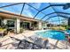 Enjoy the screened pool area with lounge chairs and a dining area at 11479 Blackfin St, Venice, FL 34292