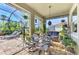 Relaxing screened patio with seating area, lush plants, and a view of the pool at 11479 Blackfin St, Venice, FL 34292