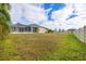 Large backyard with grassy area and home view at 1171 Yarmouth St, Port Charlotte, FL 33952