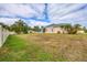 Large backyard with grassy area and screened enclosure at 1171 Yarmouth St, Port Charlotte, FL 33952