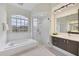 Bathroom with soaking tub, walk-in shower, and and vanities at 1171 Yarmouth St, Port Charlotte, FL 33952