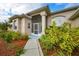 Inviting front entrance with landscaped walkway and screened porch at 1171 Yarmouth St, Port Charlotte, FL 33952