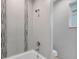 Bathroom with a shower/tub combo and stylish tile work at 119 White Pine Dr, Rotonda West, FL 33947