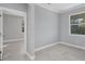 Spacious bedroom with grey walls, tile flooring, and access to another room at 119 White Pine Dr, Rotonda West, FL 33947