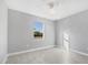 Bright bedroom with grey walls, tile flooring, and a ceiling fan at 119 White Pine Dr, Rotonda West, FL 33947