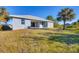 Gray house exterior with a spacious backyard at 119 White Pine Dr, Rotonda West, FL 33947