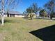 Large backyard with mature trees and open space at 13278 Carter Ave, Port Charlotte, FL 33981