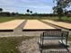 Three bocce ball courts and a bench at 13278 Carter Ave, Port Charlotte, FL 33981