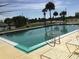 Relaxing community pool with lounge chairs and surrounding landscape at 13278 Carter Ave, Port Charlotte, FL 33981