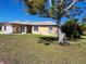 Single-story home with attached garage and mature landscaping at 13278 Carter Ave, Port Charlotte, FL 33981