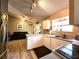 Bright kitchen with white cabinets and a view into the living room at 13278 Carter Ave, Port Charlotte, FL 33981