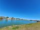 Scenic view of a tranquil lake with houses in the background at 13278 Carter Ave, Port Charlotte, FL 33981