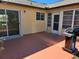 Backyard patio with sliding glass doors and grill at 13278 Carter Ave, Port Charlotte, FL 33981