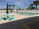 Community pool with lounge chairs and tables at 13278 Carter Ave, Port Charlotte, FL 33981