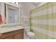 Simple bathroom with a single sink and striped shower curtain at 13376 Creekside Ln, Port Charlotte, FL 33953