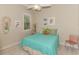 Cozy bedroom with a teal comforter and beach-themed decor at 13376 Creekside Ln, Port Charlotte, FL 33953