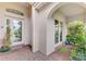 Front entry with double doors and potted plants at 13376 Creekside Ln, Port Charlotte, FL 33953